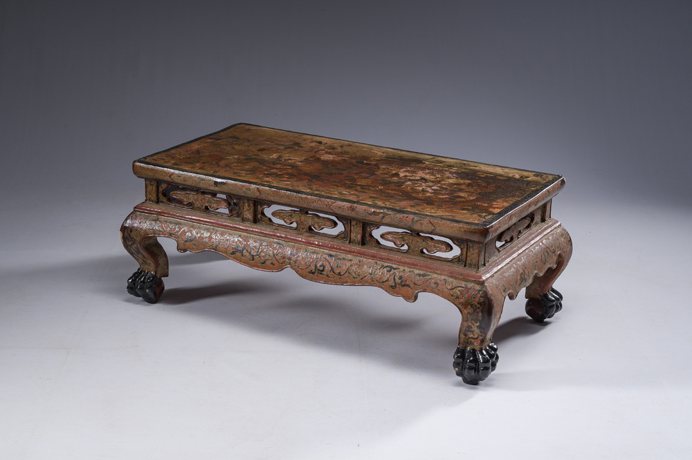 A Chinese rectangular carved and lacquered wooden low table with peach design, Qing