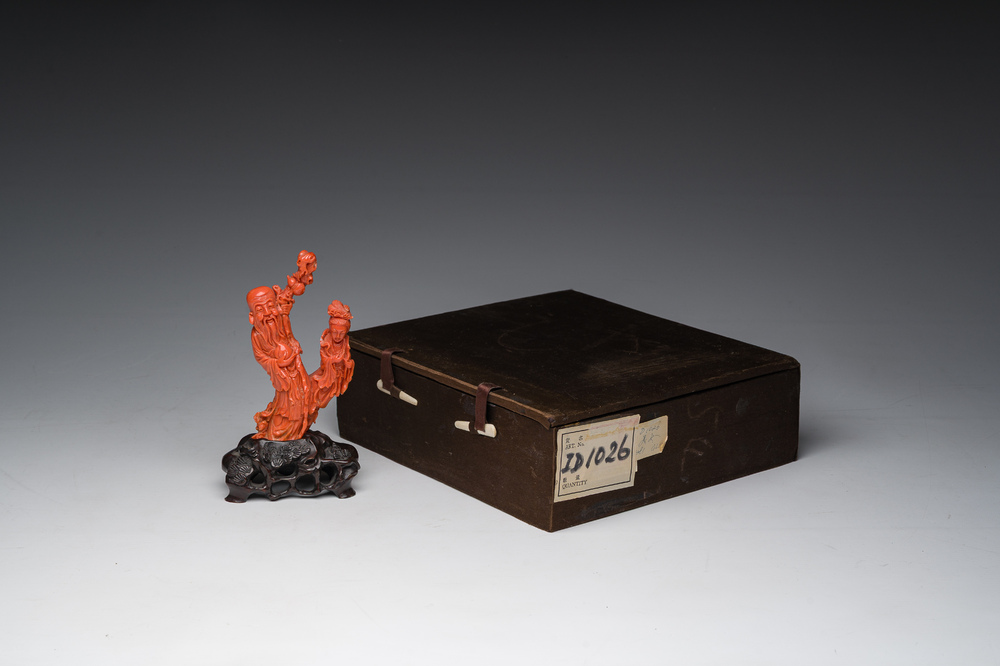 A Chinese red coral group with the 'Star God' Shou Xing and a lady, 19th/20th C.