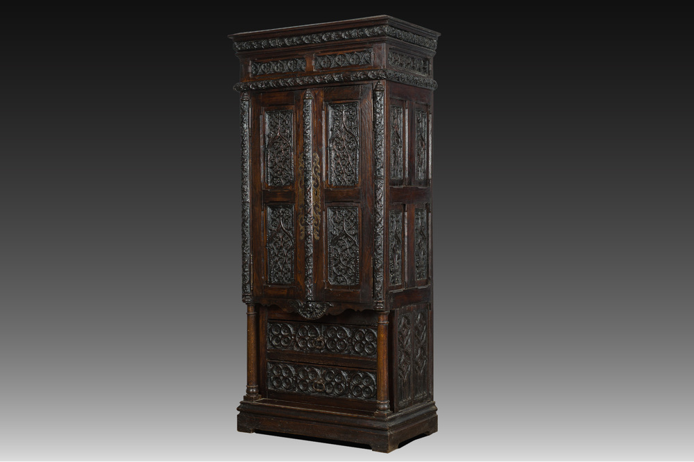A French Gothic Revival carved wooden cabinet with two doors and two drawers with a fleur-de-lis design, 19th C.