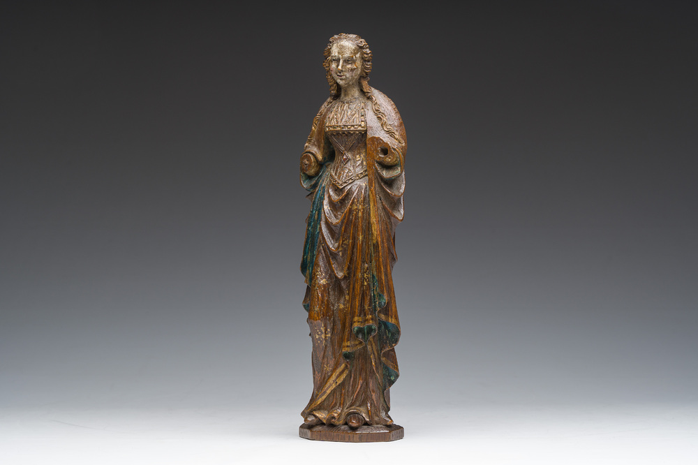 A Flemish carved, polychrome decorated and gilt oak sculpture of a female saint or 'Poup&eacute;e de Malines', 16th C.