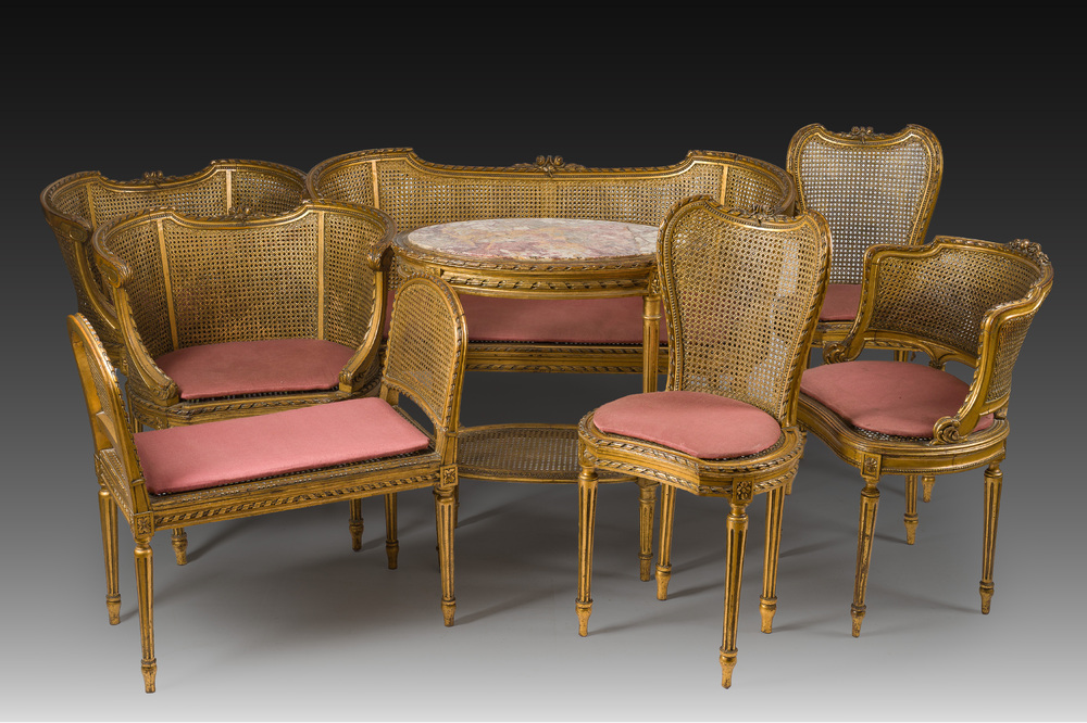A French Louis XVI style eight-piece carved and gilt wooden salon set, 19th/20th C.