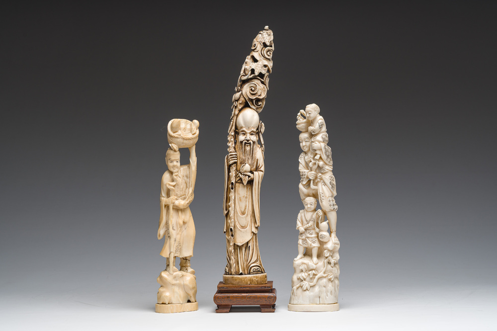 A Chinese carved ivory 'Shou Lao' figure and two walrus ivory groups depicting the local population, 19th/20th C.