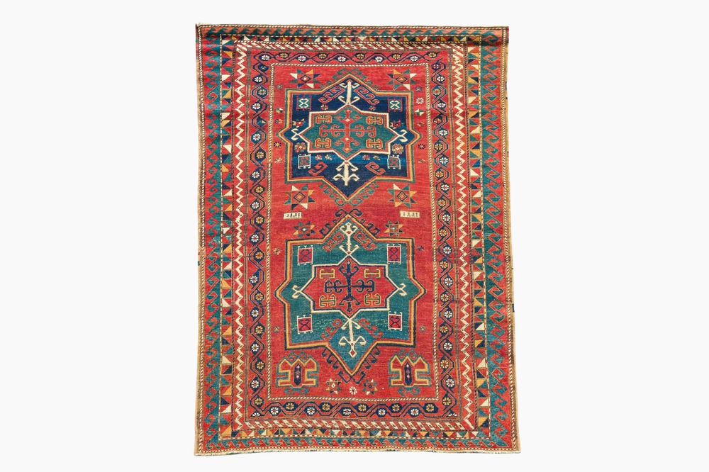 A Kazakh wool Fachralo rug with geometric and floral design, first half 20th C.