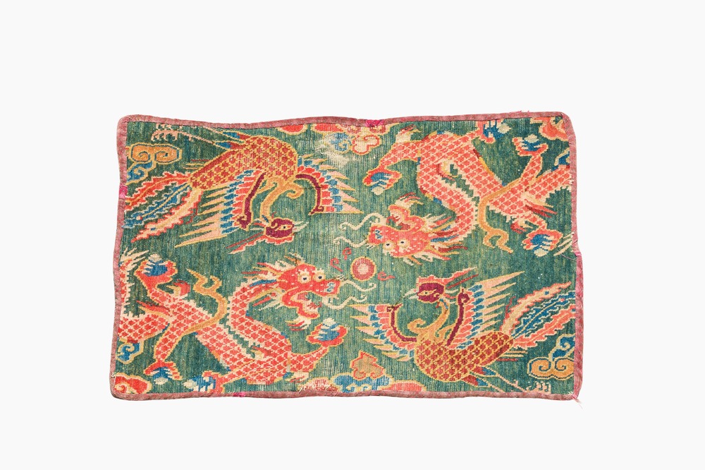 A Tibetan wool 'dragons and phoenixes' rug, 19th C.