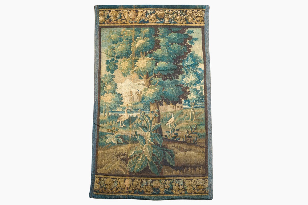 A Flemish wall tapestry with birds in a landscape with a castle in the background, 17th C.