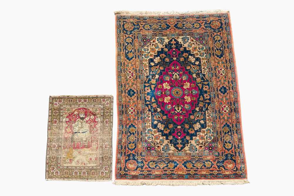 A Persian Kerman (Kirman) rug with figurative design and an Isfahan rug with floral design, wool on cotton, 20th C.