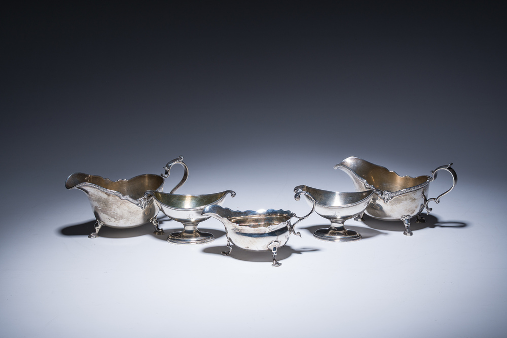 Three English silver sauce boats and a pair of 'armorial' salt cellars, 18th/20th C.