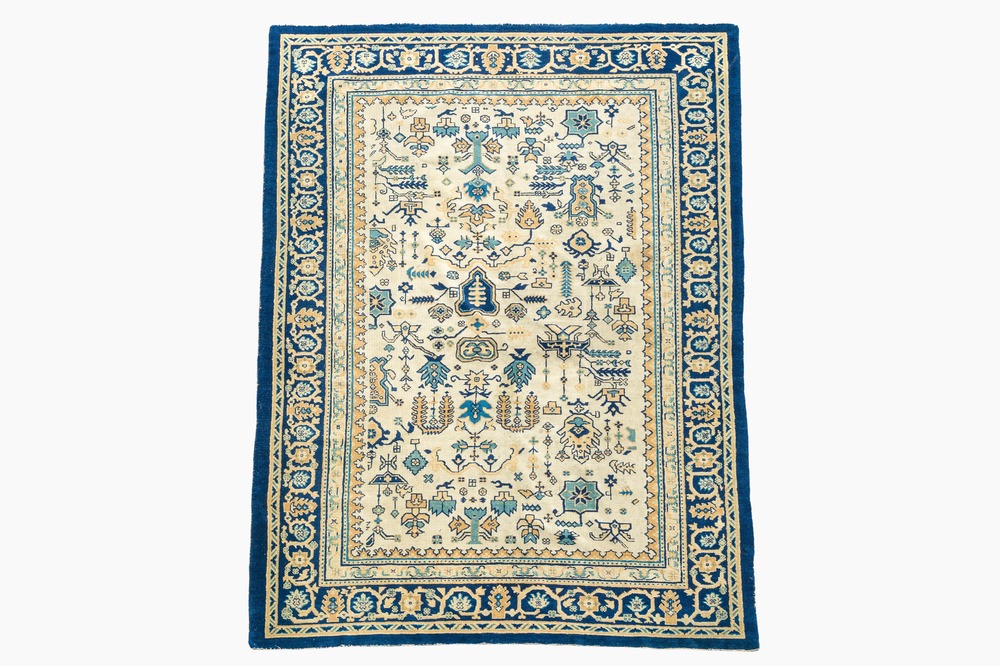 A Chinese wool carpet with floral geometric design, first quarter 20th C.