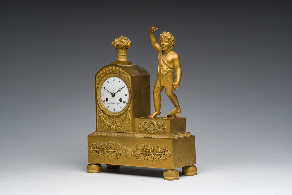 A Ghent gilt bronze mantel clock crowned with a male Bacchante, 19th C.