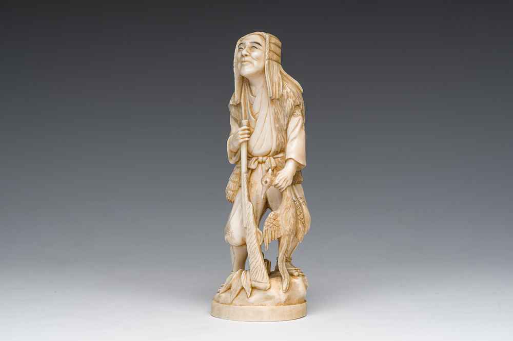A Japanese ivory okimono of a hunter with his hunting trophy, signed, Meiji, ca. 1900