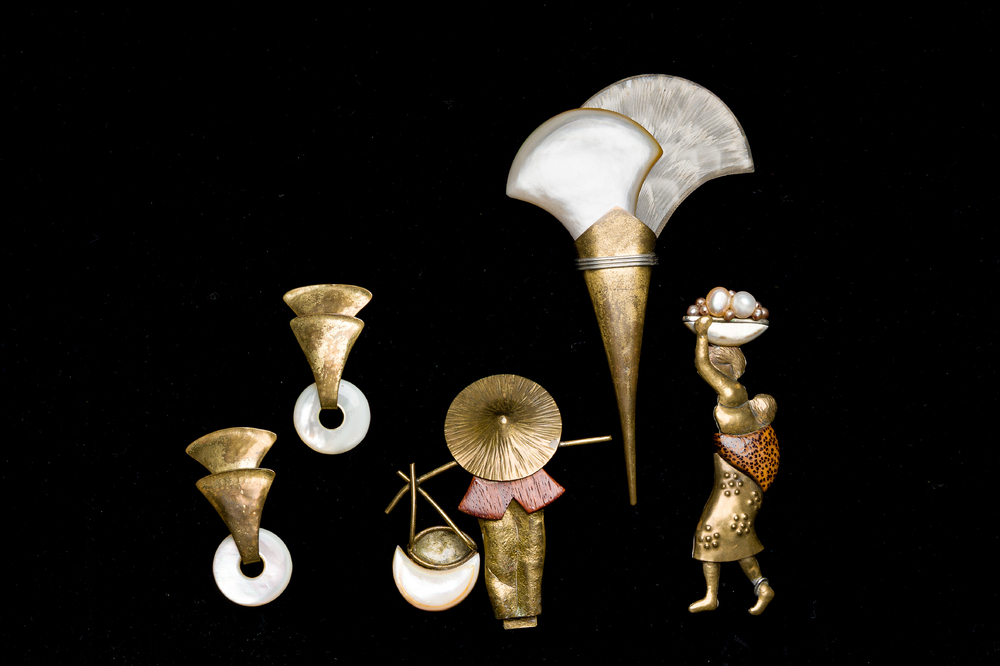 A varied collection of brass jewelry finished with a.o. mother-of-pearl, pearls and wood, marked 'Fabrice Paris', 20th C.