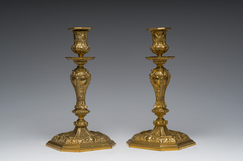 A pair of French gilt bronze R&eacute;gence style candlesticks with floral design, late 19th C.