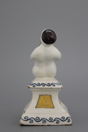 A French ceramic figure of a boy on a base, 18th C.