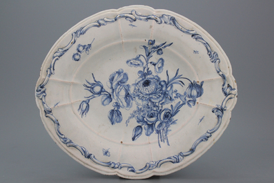 A large French faience relief molded oval blue and white dish with a very fine floral decoration, 18th C.