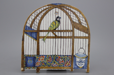 A Dutch Delft polychrome trompe l'oeil  plaque with a bird in a cage, 18th C.