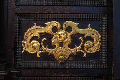A South-German ebony veneer and gilded copper cabinet, 17th C.