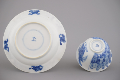 A Chinese porcelain blue and white cup and saucer with a "Rotterdam Riot" decor, Kangxi