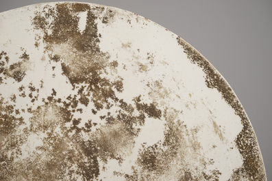 A Chinese porcelain famille rose round tile plaque with an erotical scene, 19th C.