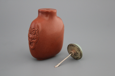 A Chinese polished gold stone snuff bottle with celadon jade lid