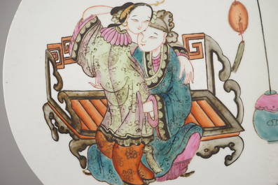 A Chinese porcelain famille rose round tile plaque with an erotical scene, 19th C.