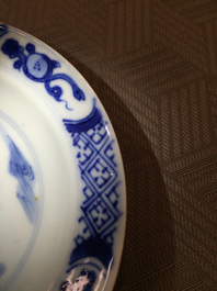 A Chinese porcelain blue and white cup and saucer with a "Rotterdam Riot" decor, Kangxi