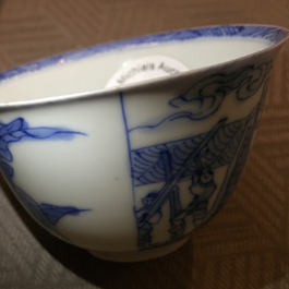 A Chinese porcelain blue and white cup and saucer with a "Rotterdam Riot" decor, Kangxi