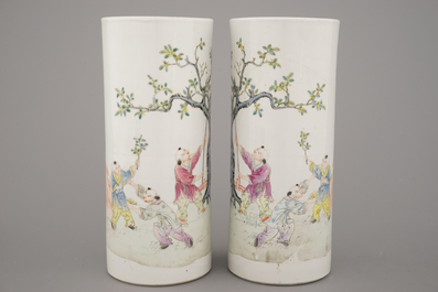 A pair of Chinese porcelain hat stands with playing boys, 19th C.