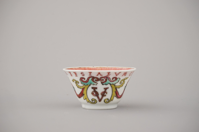 A Chinese porcelain famille rose armorial cup and saucer with VOC coat of arms, dated 1728, Yongzheng