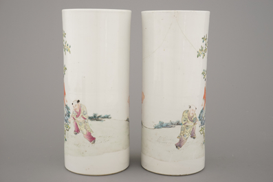 A pair of Chinese porcelain hat stands with playing boys, 19th C.