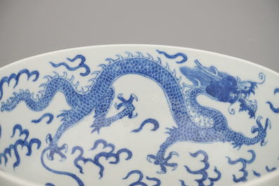 A pair of Chinese porcelain blue and white dragon bowls, 19th C.