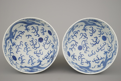 A pair of Chinese porcelain blue and white dragon bowls, 19th C.