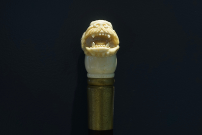 A Chinese carved ivory and wood walking stick or cane with a dragon's head, 19th C.
