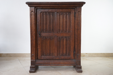 A gothic revival one door oak cabinet, 19th C.