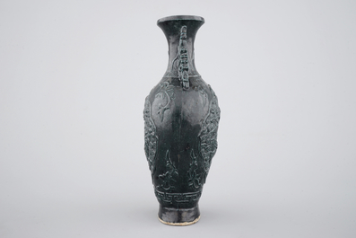 A Chinese black glazed relief-moulded vase, 19/20th C.
