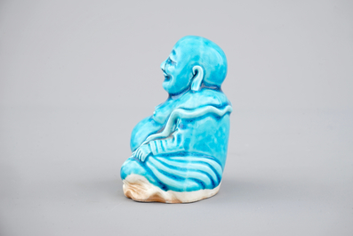 A Chinese porcelain turquoise figure of a seated Buddha, Kangxi