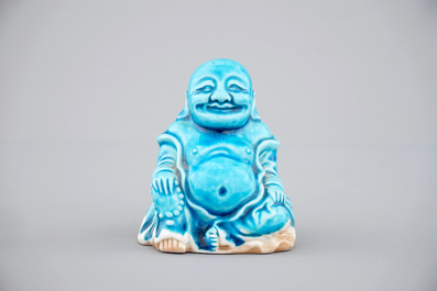 A Chinese porcelain turquoise figure of a seated Buddha, Kangxi