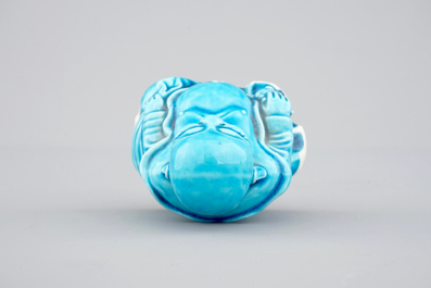 A Chinese porcelain turquoise figure of a seated Buddha, Kangxi