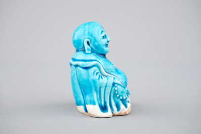 A Chinese porcelain turquoise figure of a seated Buddha, Kangxi