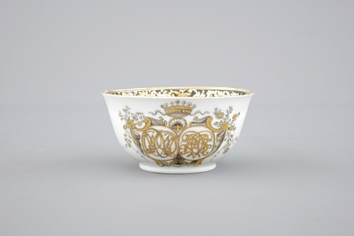 A Chinese grisaille and gilt export porcelain armorial cup and saucer, 18th C