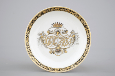 A Chinese grisaille and gilt export porcelain armorial cup and saucer, 18th C