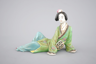 A Chinese famille rose porcelain figure of a reclining lady, 20th C