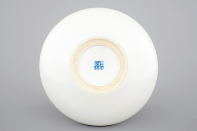 A blue and white Chinese porcelain shallow bowl with a dragon and a phoenix, 19/20th C.