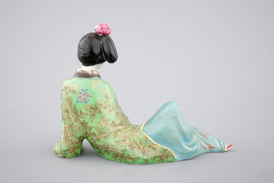 A Chinese famille rose porcelain figure of a reclining lady, 20th C