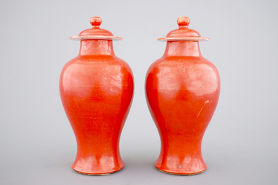 A pair of Chinese monochrome coral ground baluster vases with cover, 19th C.