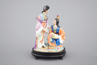 A fine Chinese porcelain figural group on a wooden stand, 20th C