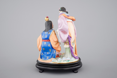 A fine Chinese porcelain figural group on a wooden stand, 20th C