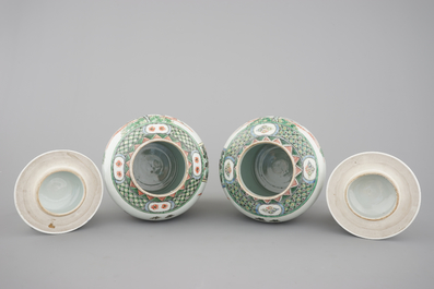 A pair of Chinese famille verte porcelain baluster vases and covers, 19th C.