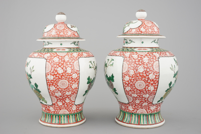 A pair of Chinese famille verte porcelain baluster vases and covers, 19th C.