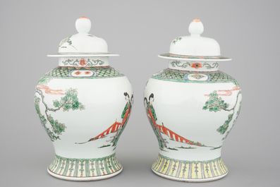 A pair of Chinese famille verte porcelain baluster vases and covers, 19th C.