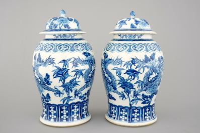 A pair of blue and white Chinese porcelain dragon vases and covers, 19th C.